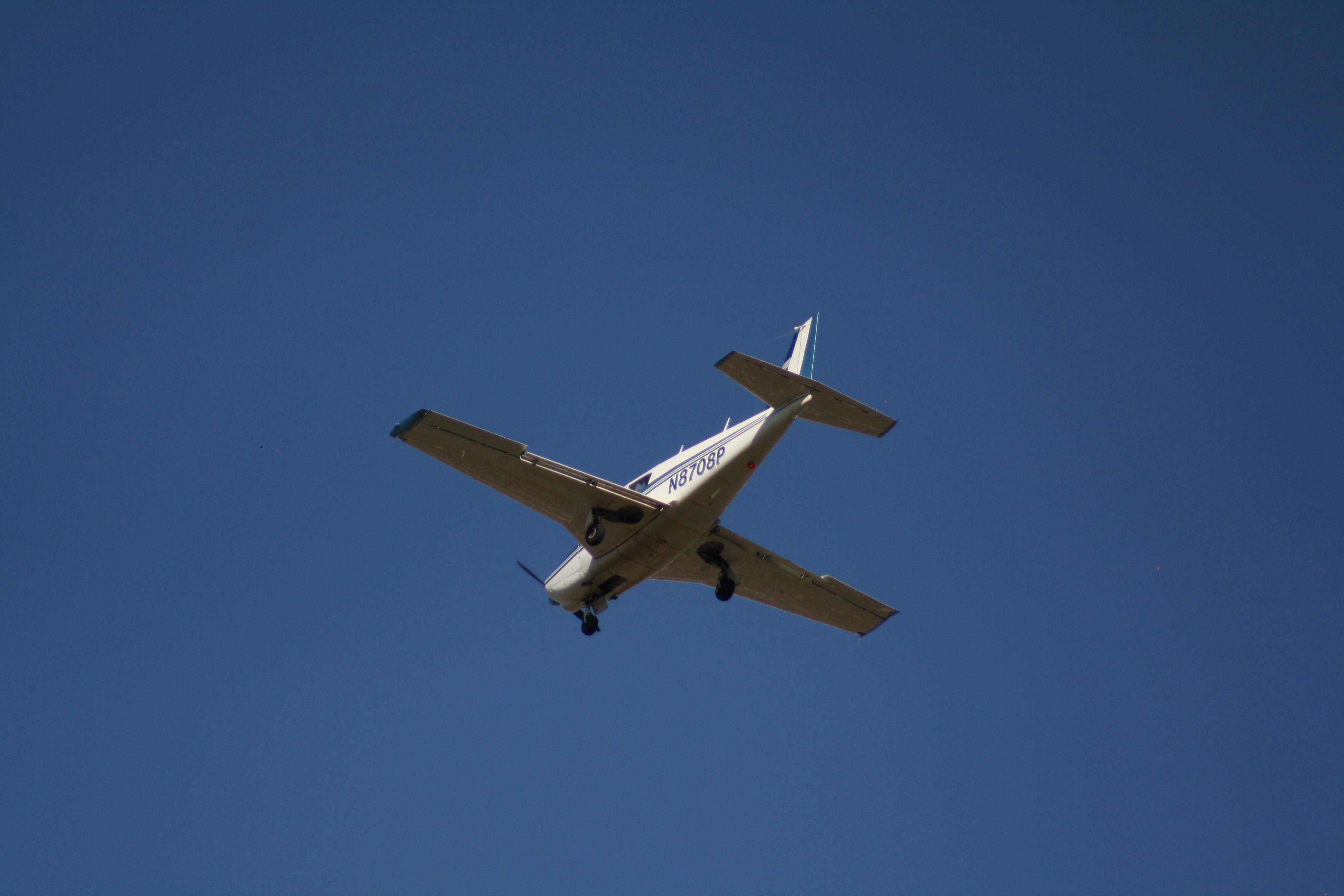Airplane flying across a blue sky